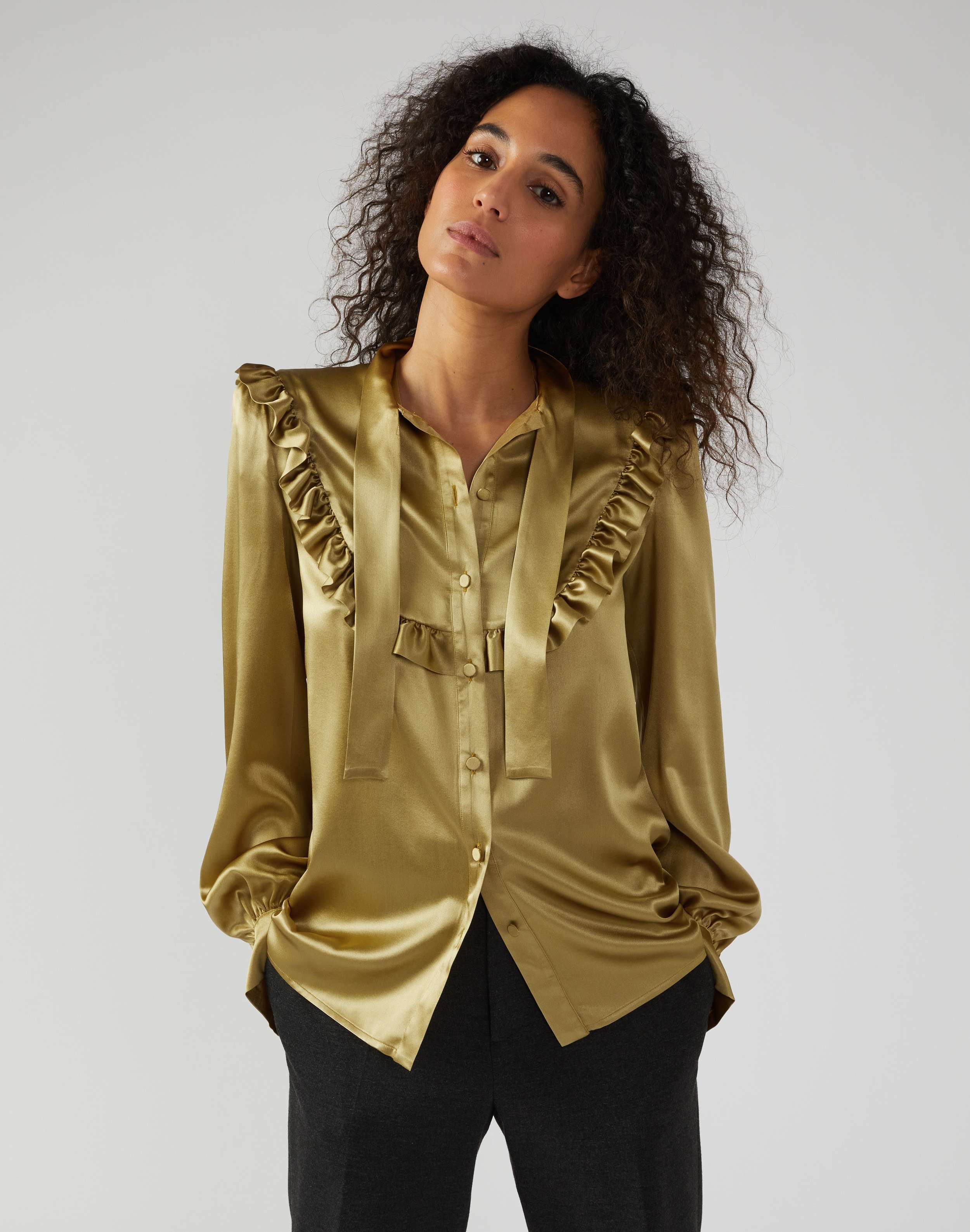 Shirt in green silk with ruffles and bow embellishment
