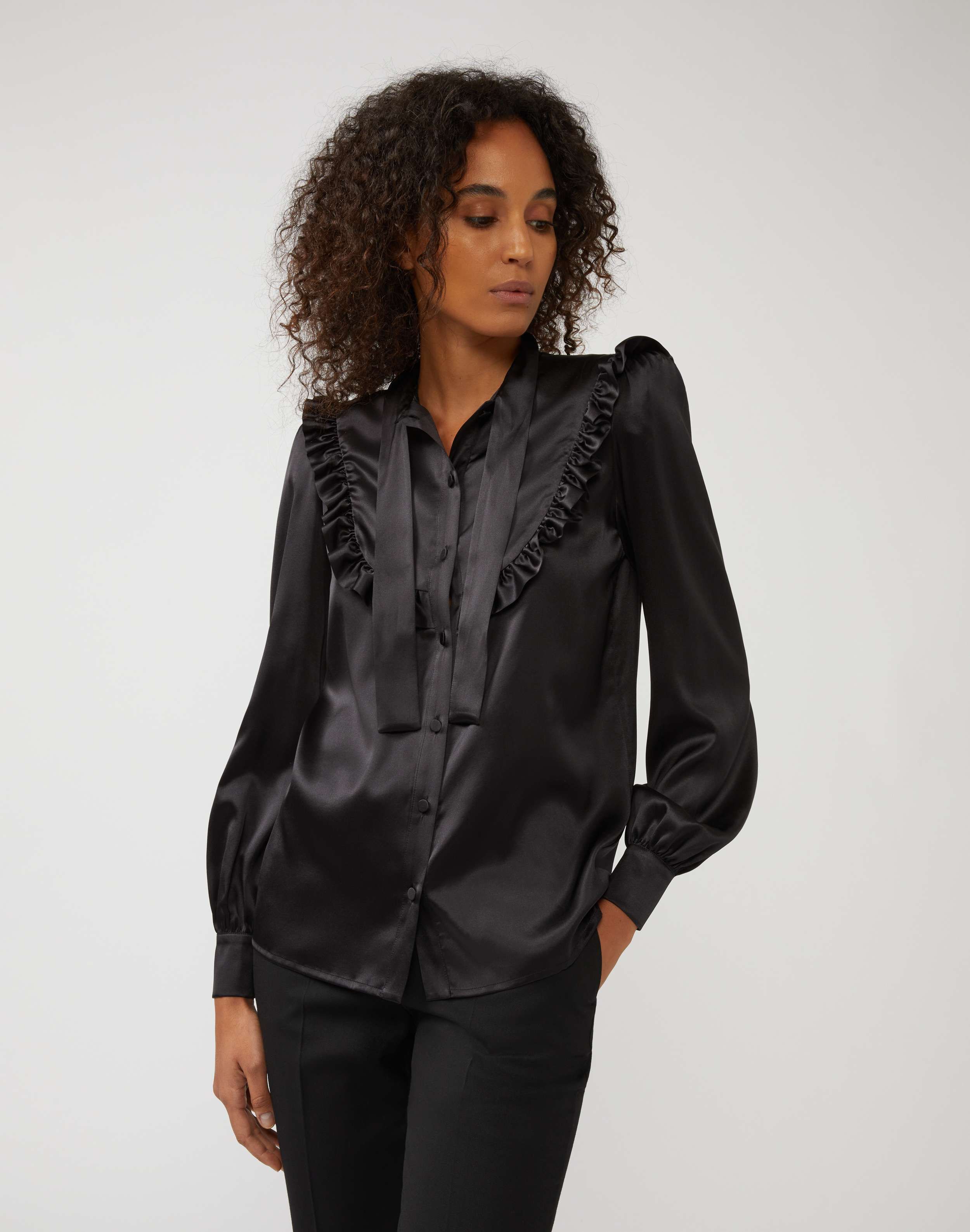 Shirt in black silk with ruffles and bow detail