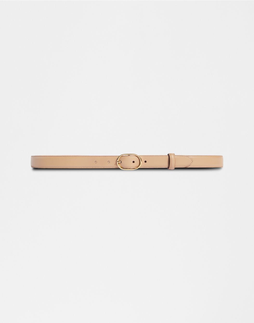 Beige leather belt with an oval buckle