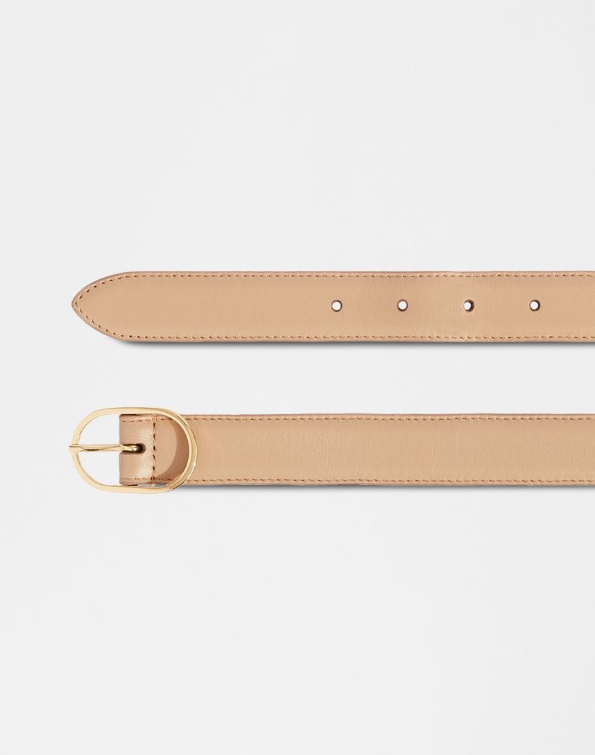 Beige leather belt with an oval buckle