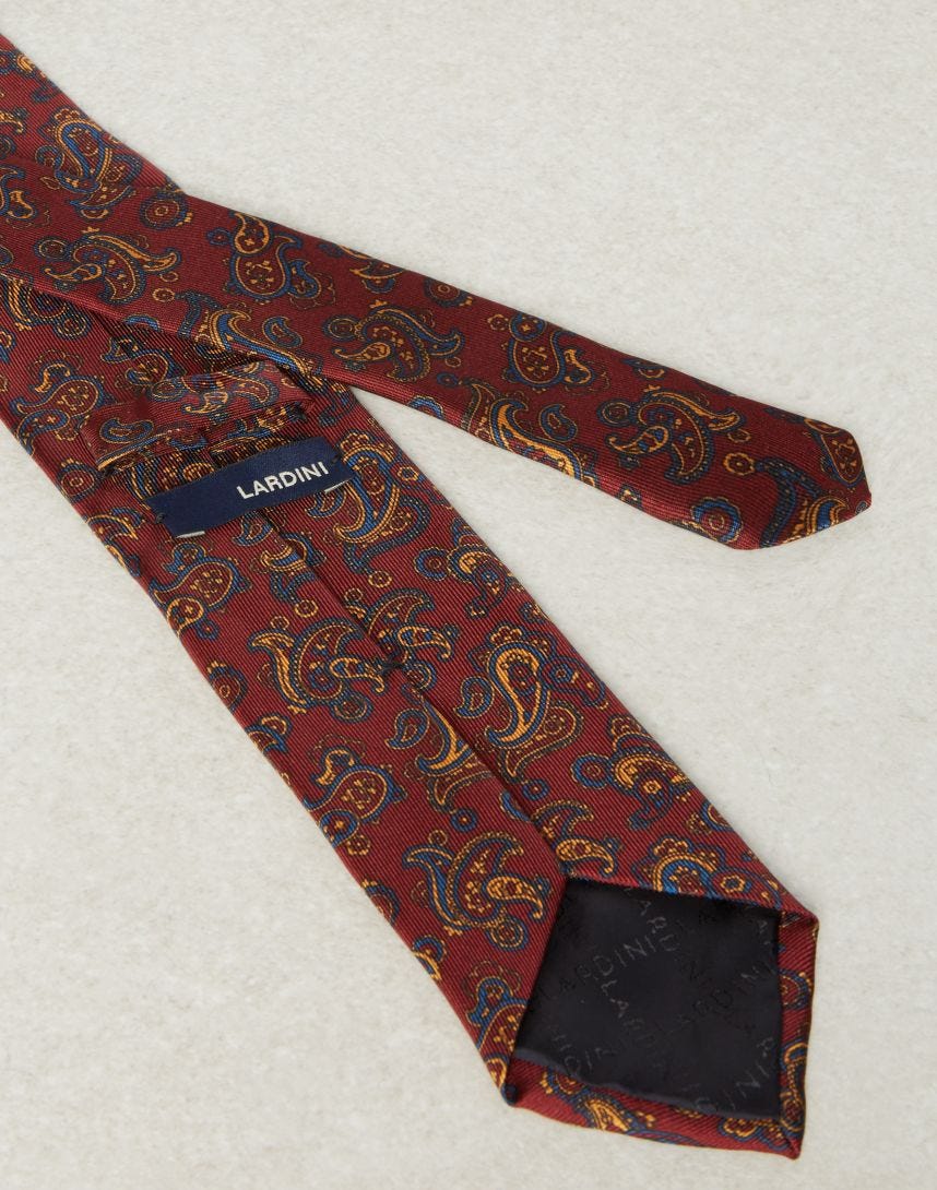 Tie in a red and ellow paisley pattern