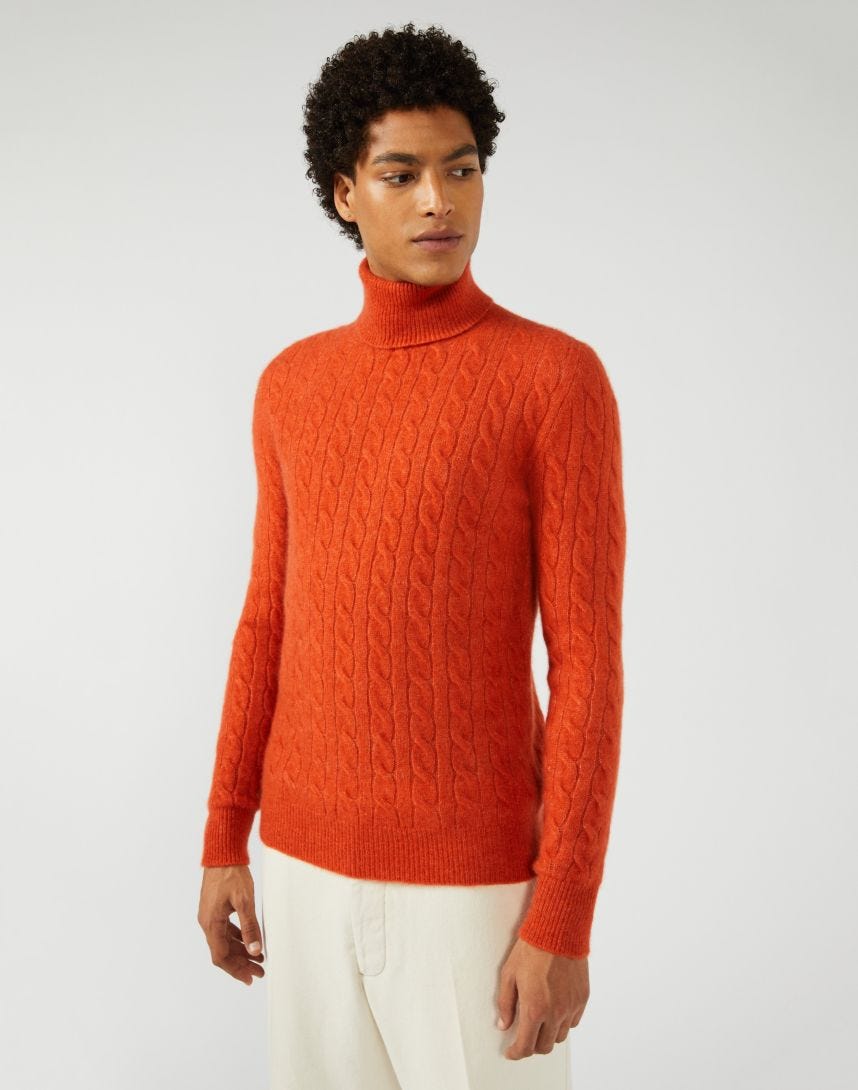 Orange turtleneck with cable-stitch patterning 